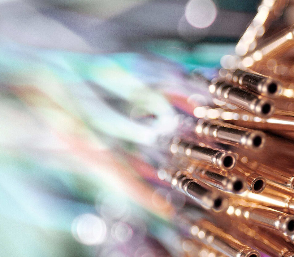 Miniaturized coaxial wires with crimp connectors, emphasizing the visible crimp indicator mark, wire test hole, and insulation support for quality control inspection.
