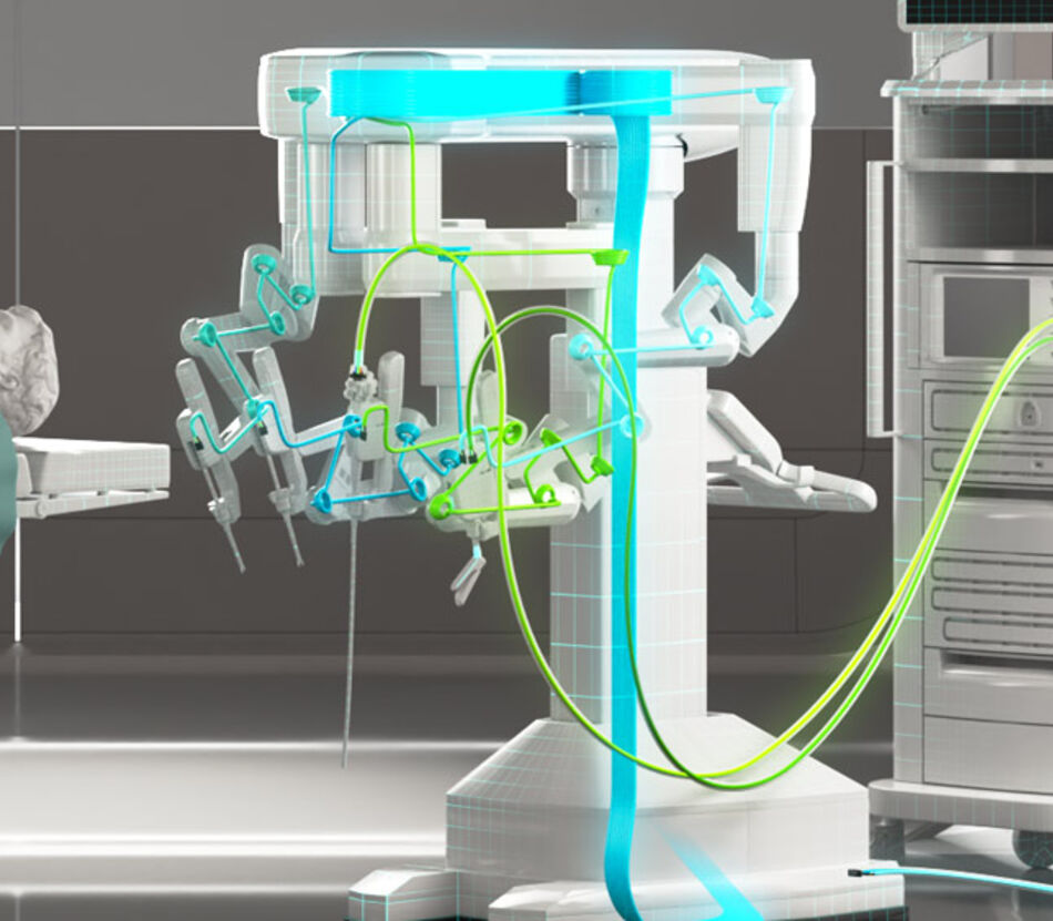 Surgery robot standing next to person on patient bed with highlighted internal cabling and outer supply cables