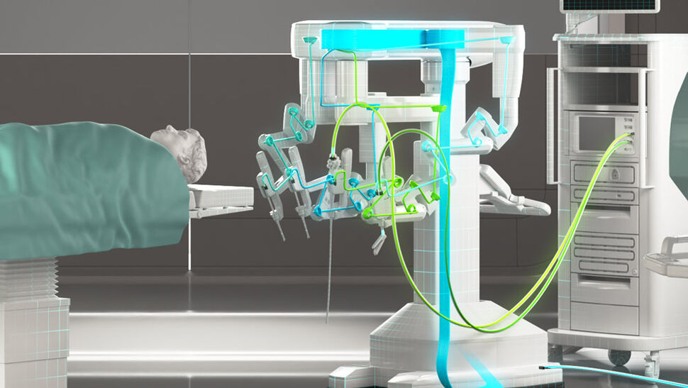 Surgery robot standing next to person on patient bed with highlighted internal cabling and outer supply cables