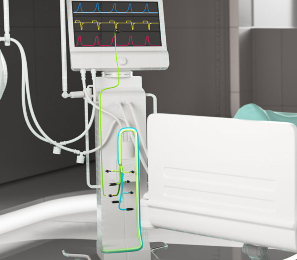 Lebenserhaltendes Beatmungsgerät am Fuß eines Patientenbetts mit angedeuteter interner Verkabelung