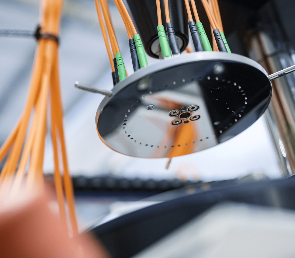 Cable ends mounted in a polishing machine for fiber optic termination.