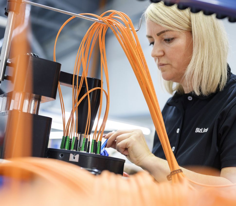 Employee fixing fiber optic cable ends into a polishing plate.