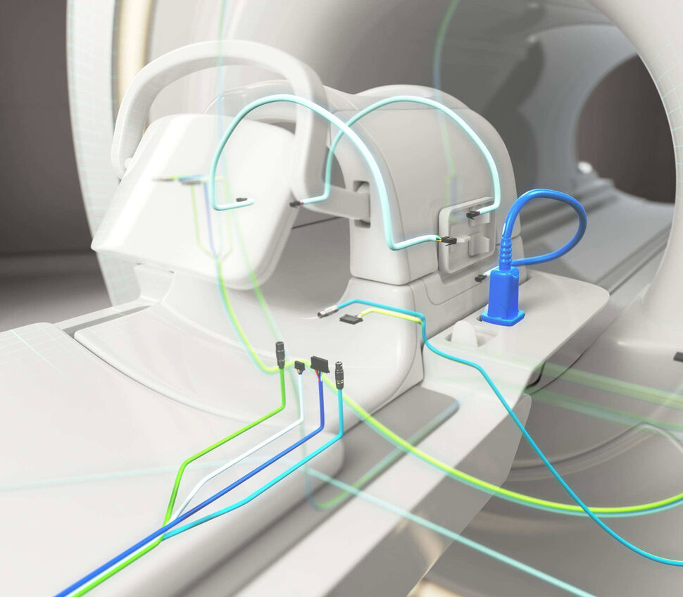 Zoom-in view of a patient table with MRI head coil and exemplary indicated body coil and MRI coil cables.