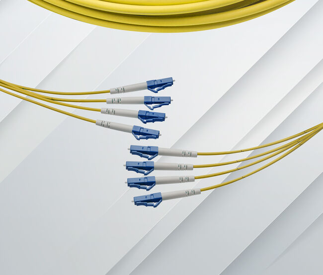 A detailed view of an LC simplex single-mode fiber optic breakout cable.